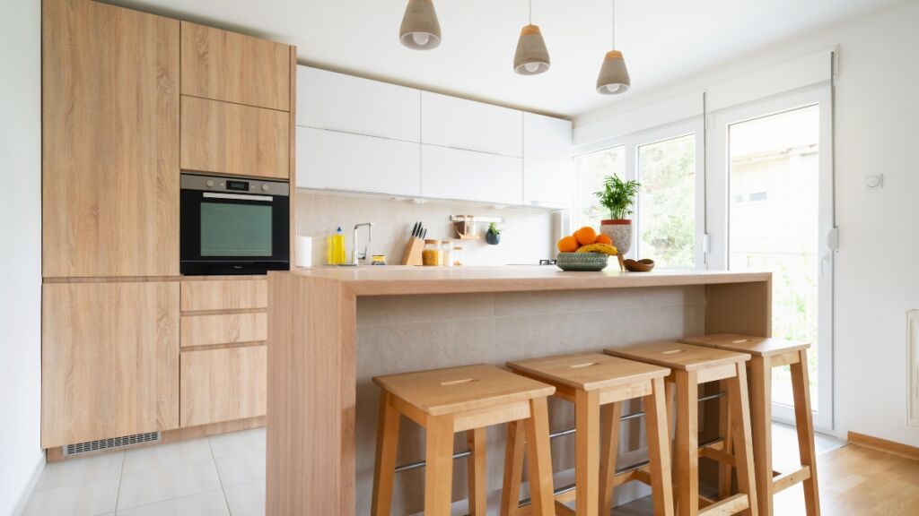 Move-in cleaning completed in a bright kitchen with dust-free cabinets and sparkling counters