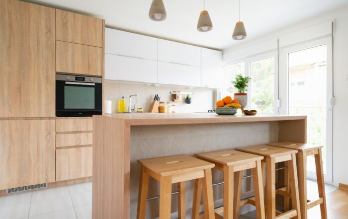 Move-in cleaning completed in a bright kitchen with dust-free cabinets and sparkling counters